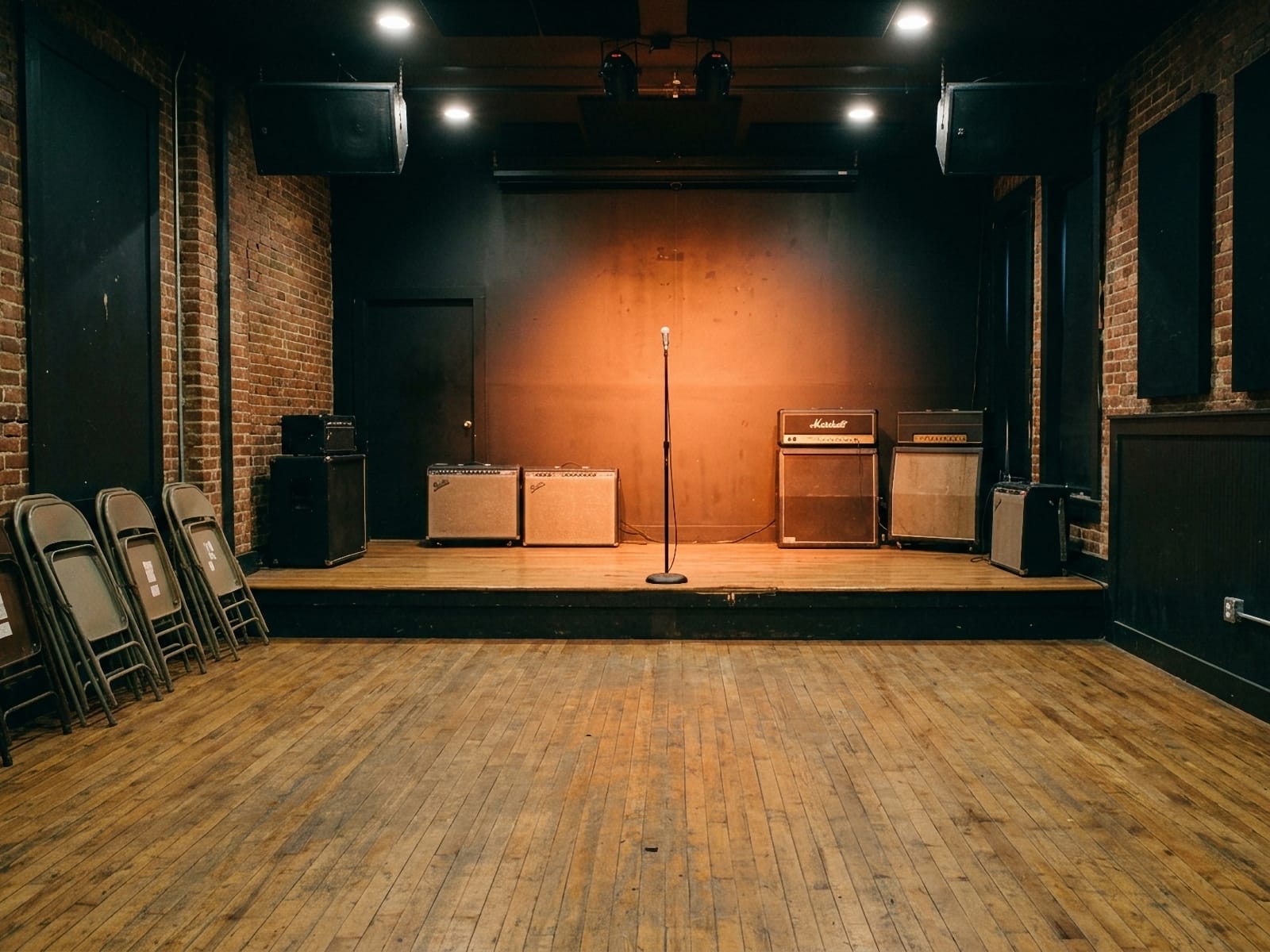 Empty small-capacity club with stage and amplifiers